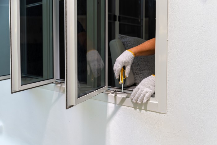 Technician repairing commercial window frame in Jacksonville, FL